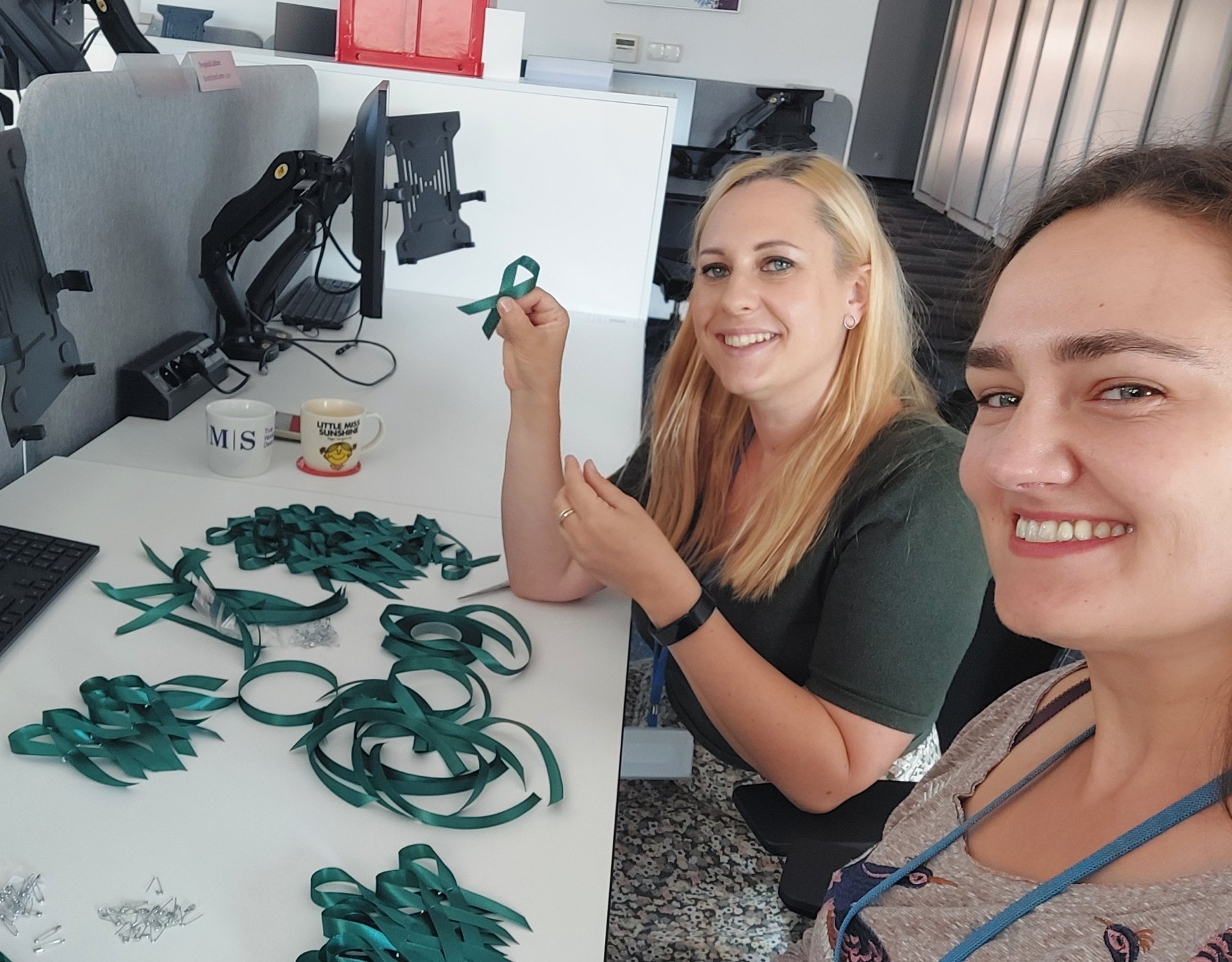 Two AMS employees in Belfast prepare support ribbons during an office-wide community service effort